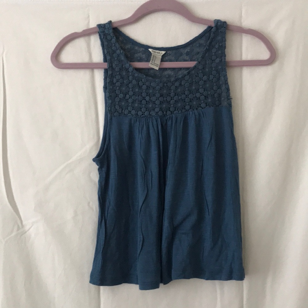 Teal tank top with lace detailing on top.